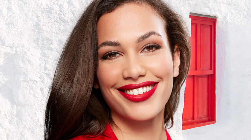 Flormar Dewy Lip Glaze collection displayed on a white surface, showcasing various glossy shades in elegant packaging with a focus on the glossy finish of the product